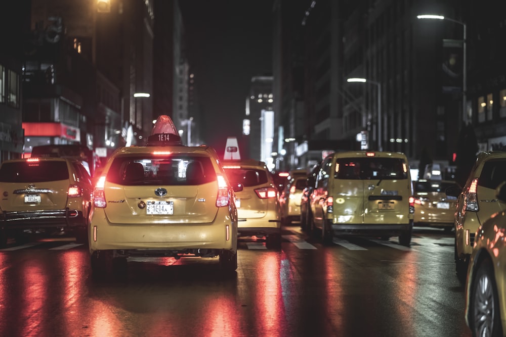 vehicles on road beside buildings during nighttime