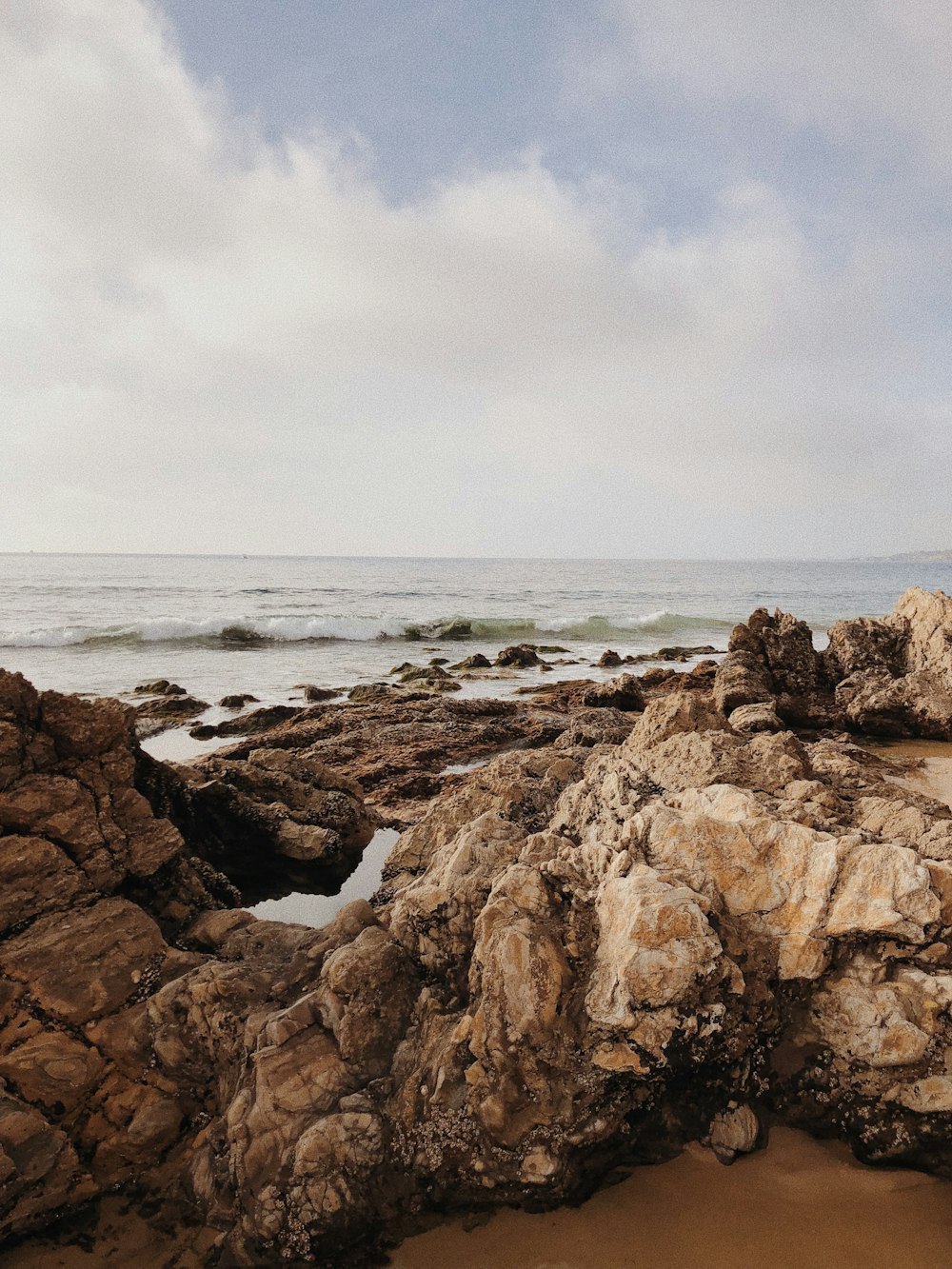 brown rocks beside beach