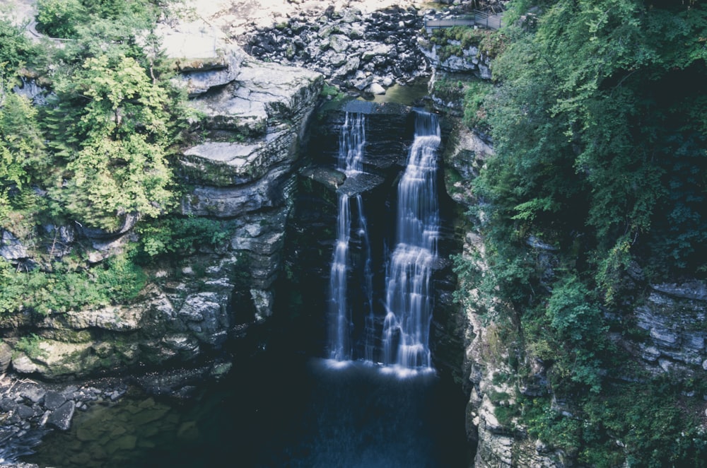 waterfalls between cliff during daytime