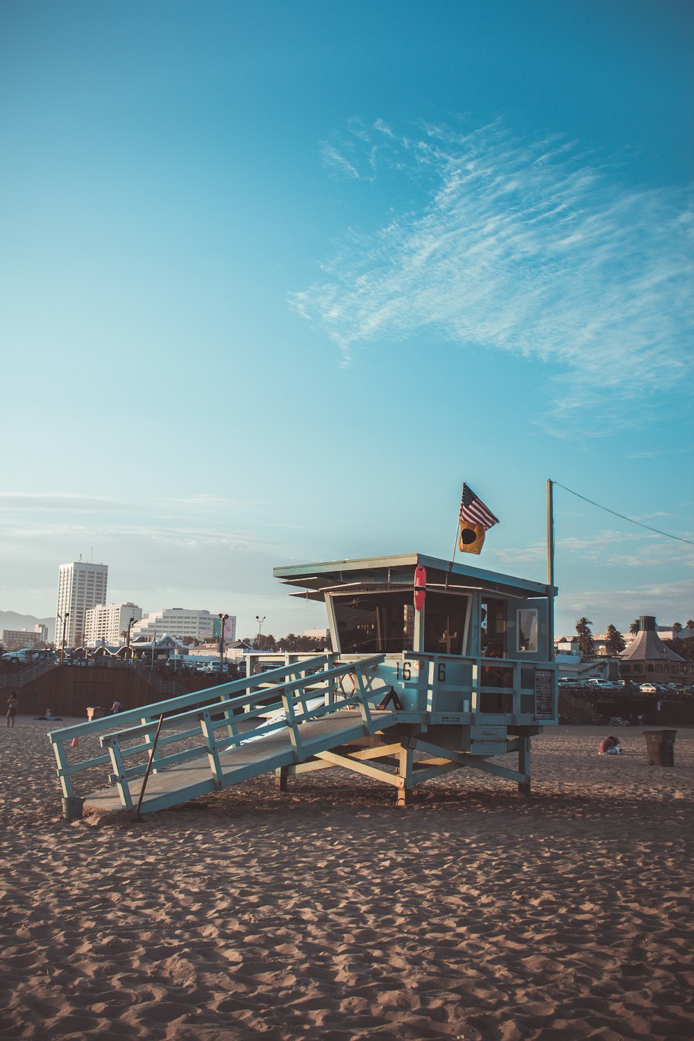 white and brown shed on sand during daytime photo