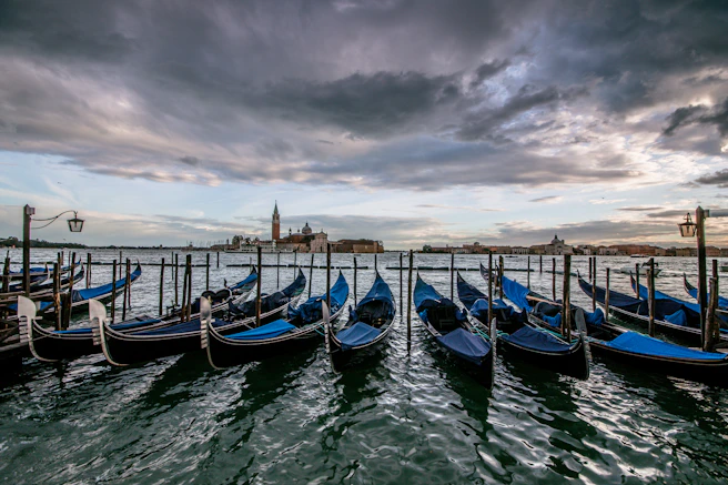 Venice, parked blue boats beside dock