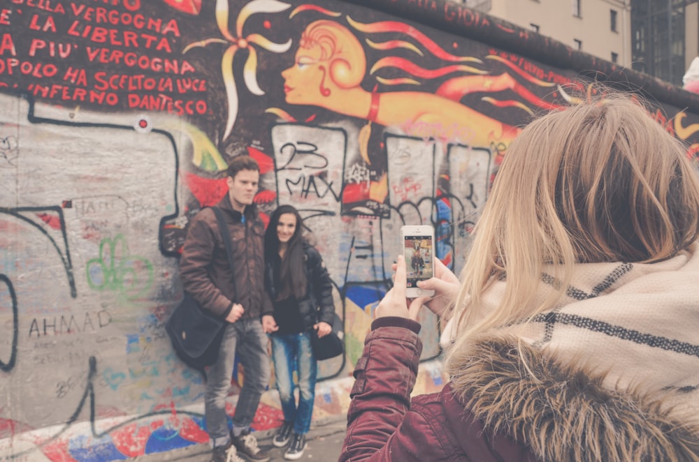 woman taking photo of couple