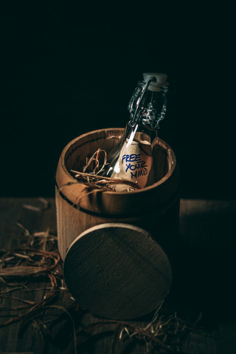 glass vial bottle in brown wooden container