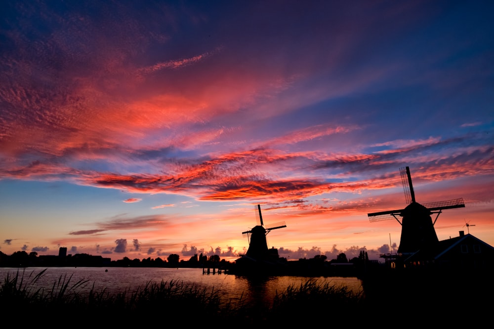 silhouette of two windmills