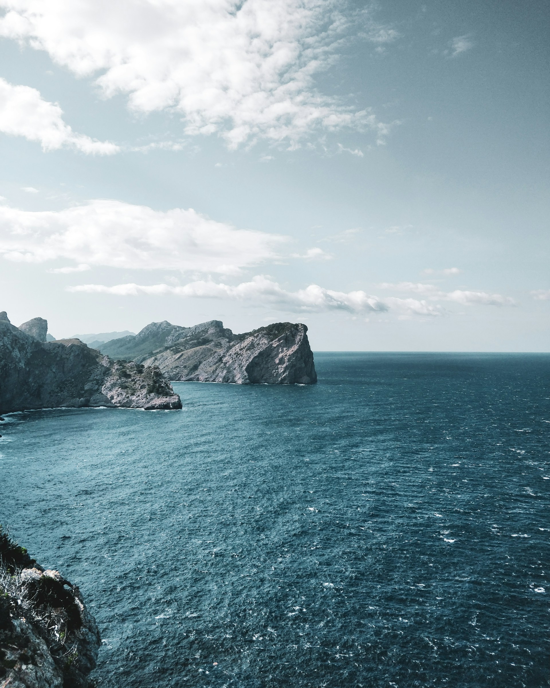 body of water under white clouds