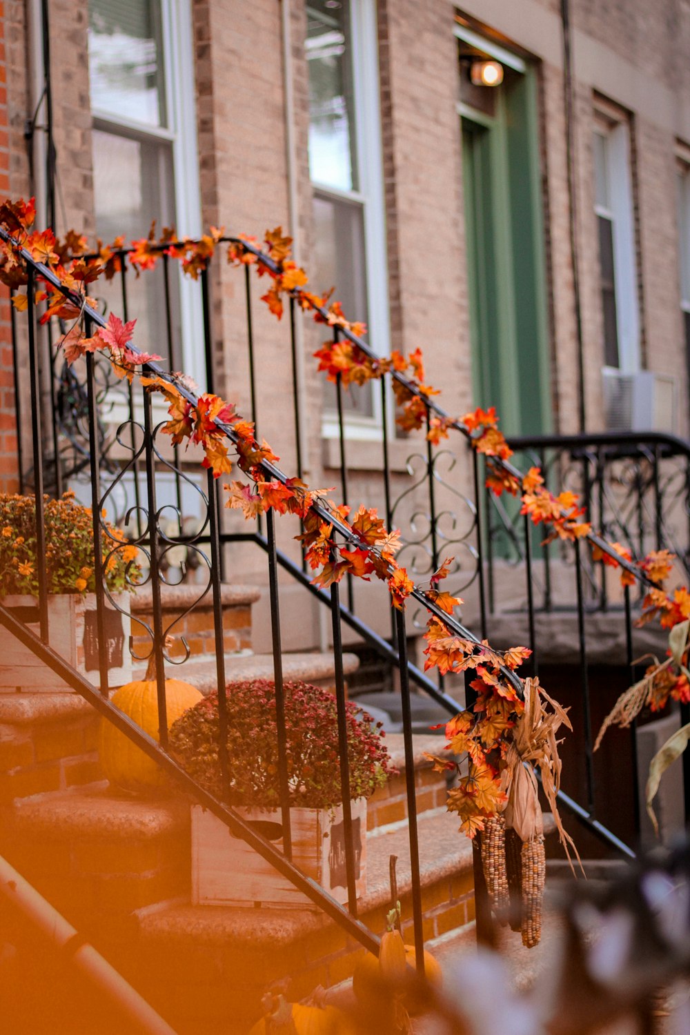 black metal stair holder with orange petaled flowers