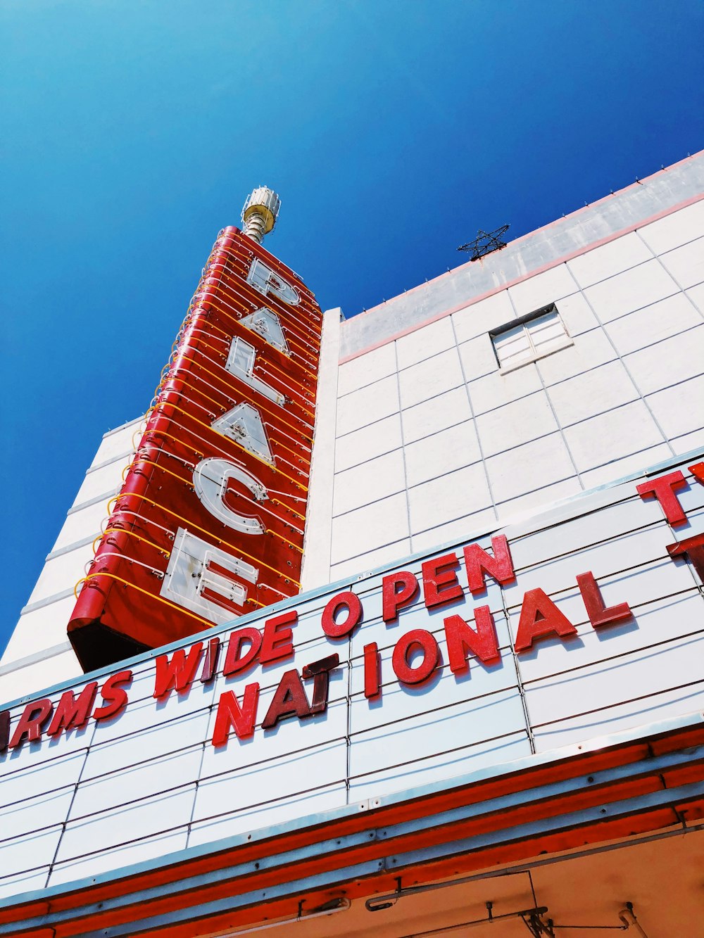 low-angle photography of Palace signage during daytime