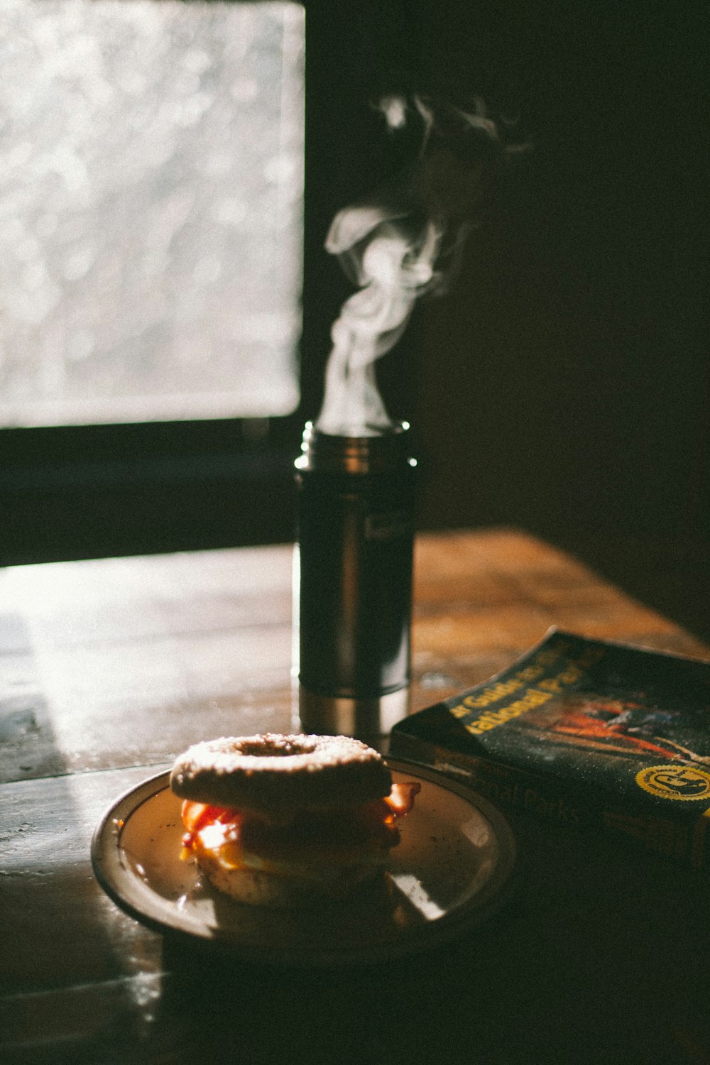 buns with filling on plate beside glass bottle