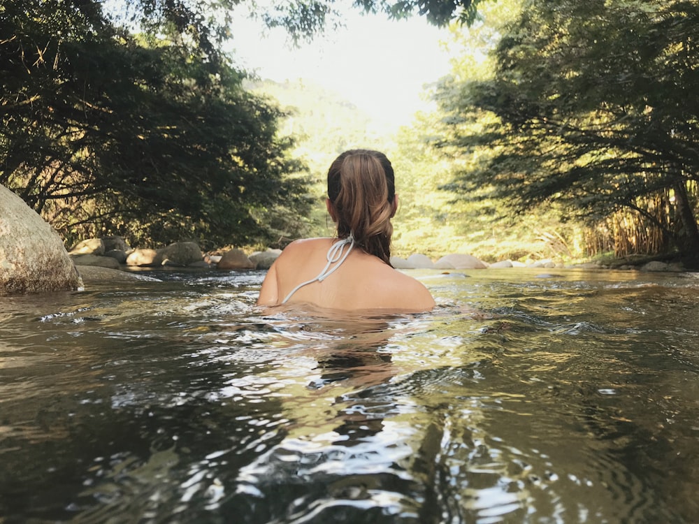 woman taking a bath on a river