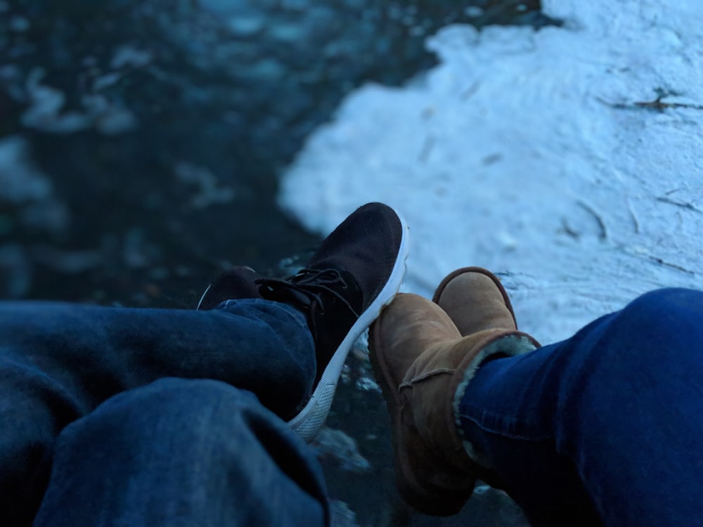 persons wearing brown boots and black sneaker