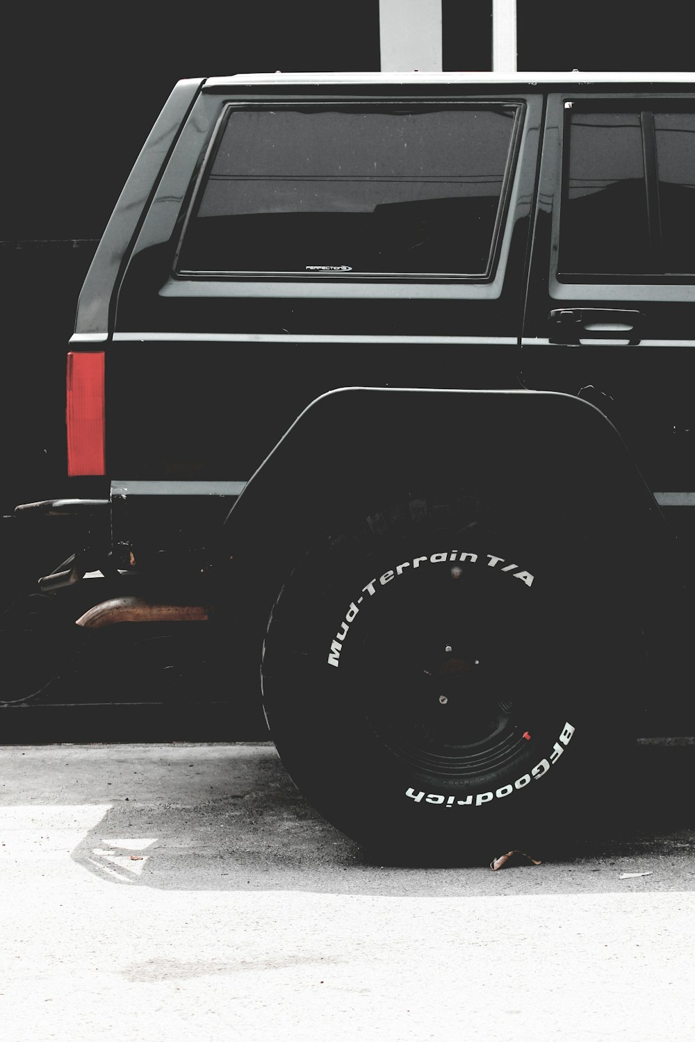 black SUV parked by wall