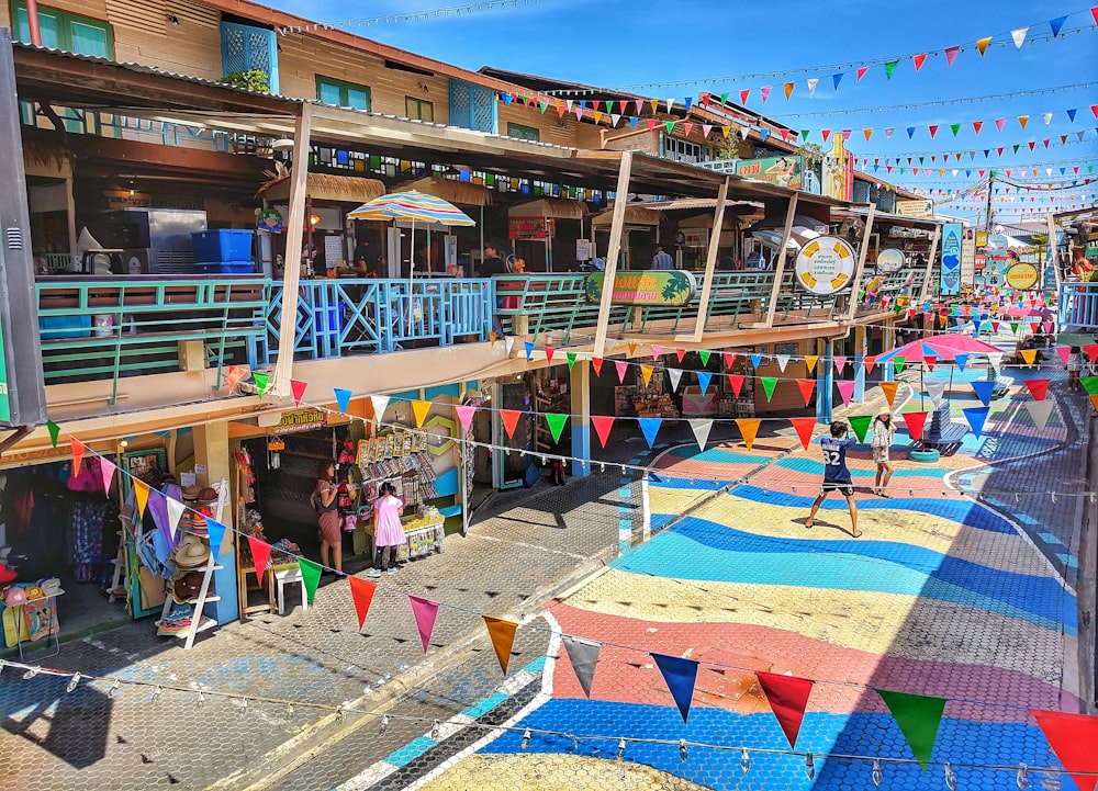 assorted-color pennant flags on street during daytime