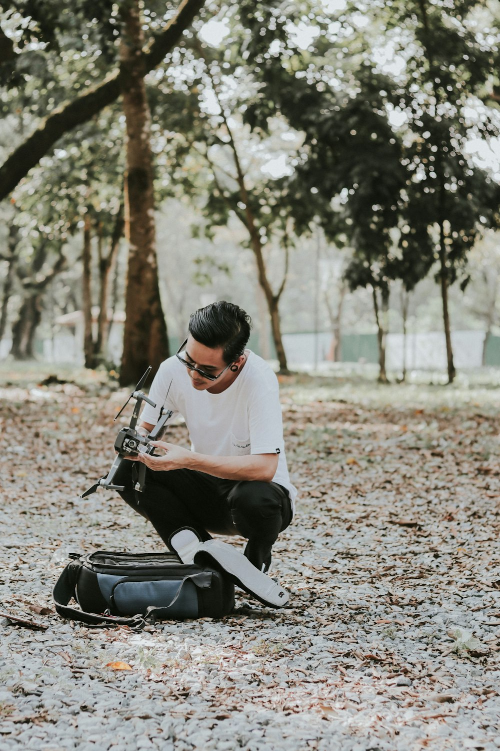 man holding black quadcopter drone