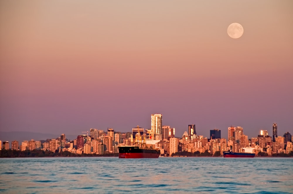 black and red container ship near high-rise buildings