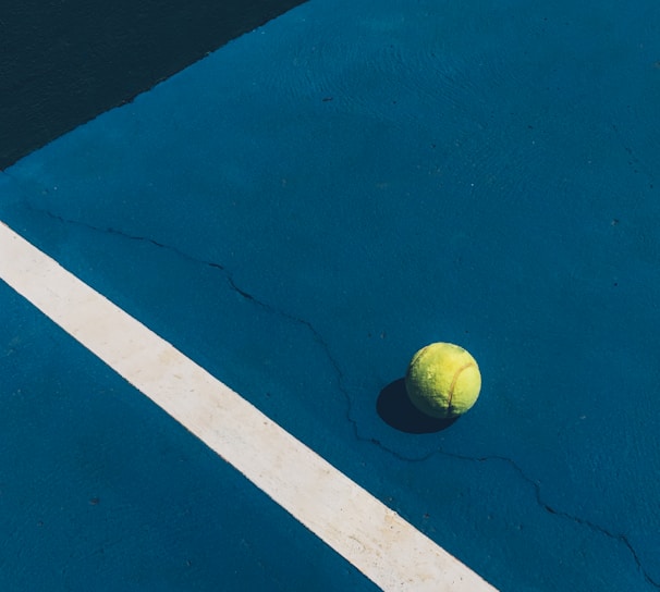 yellow tennis ball on court