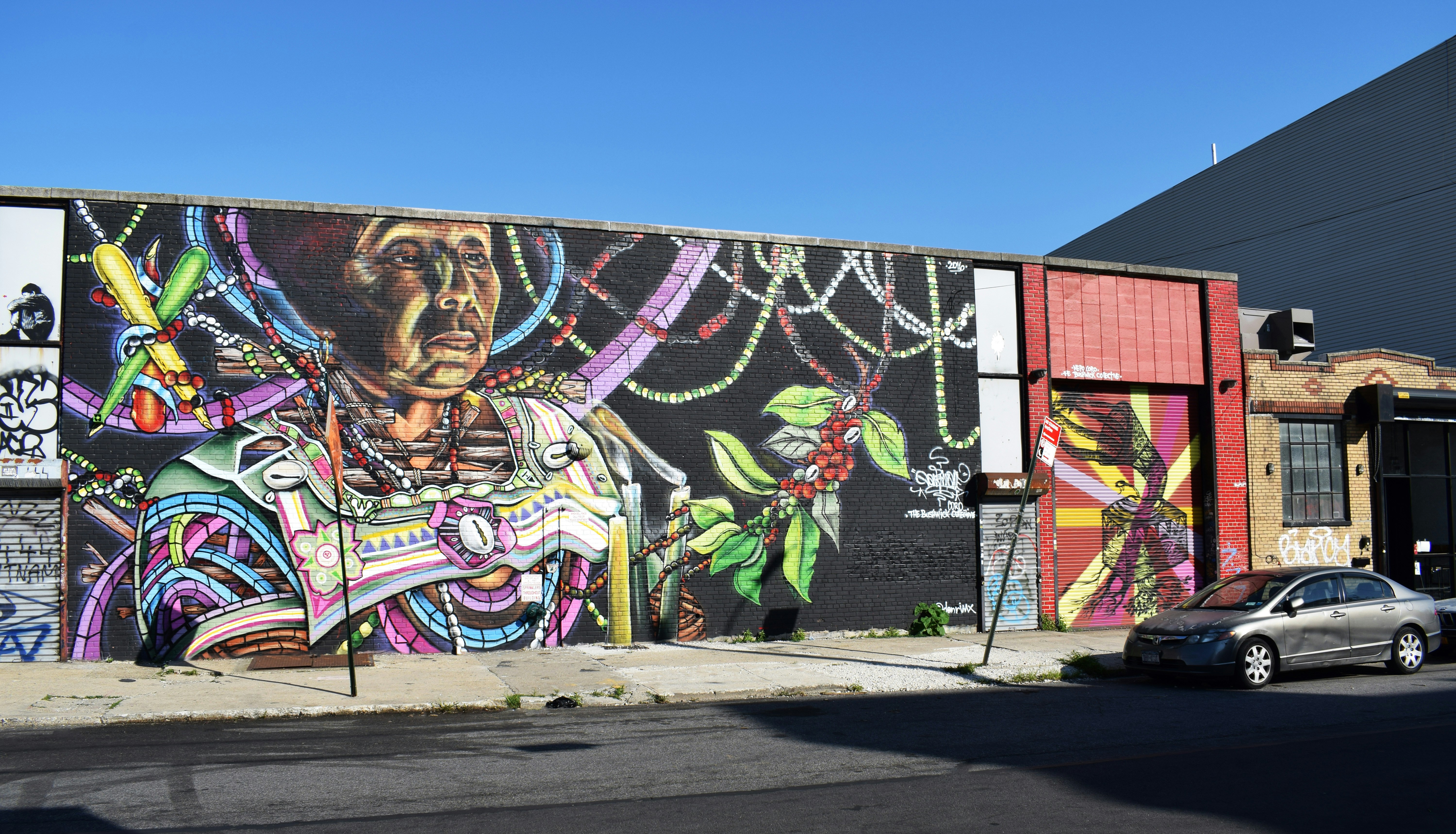gray sedan parked on road near building structure