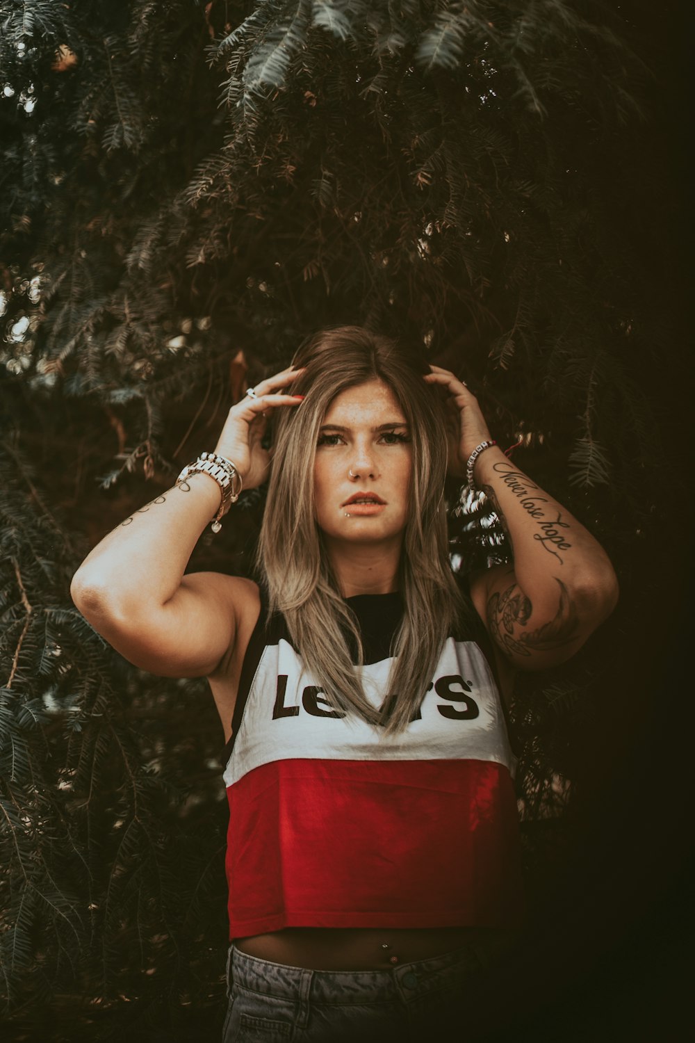 woman standing behind tree