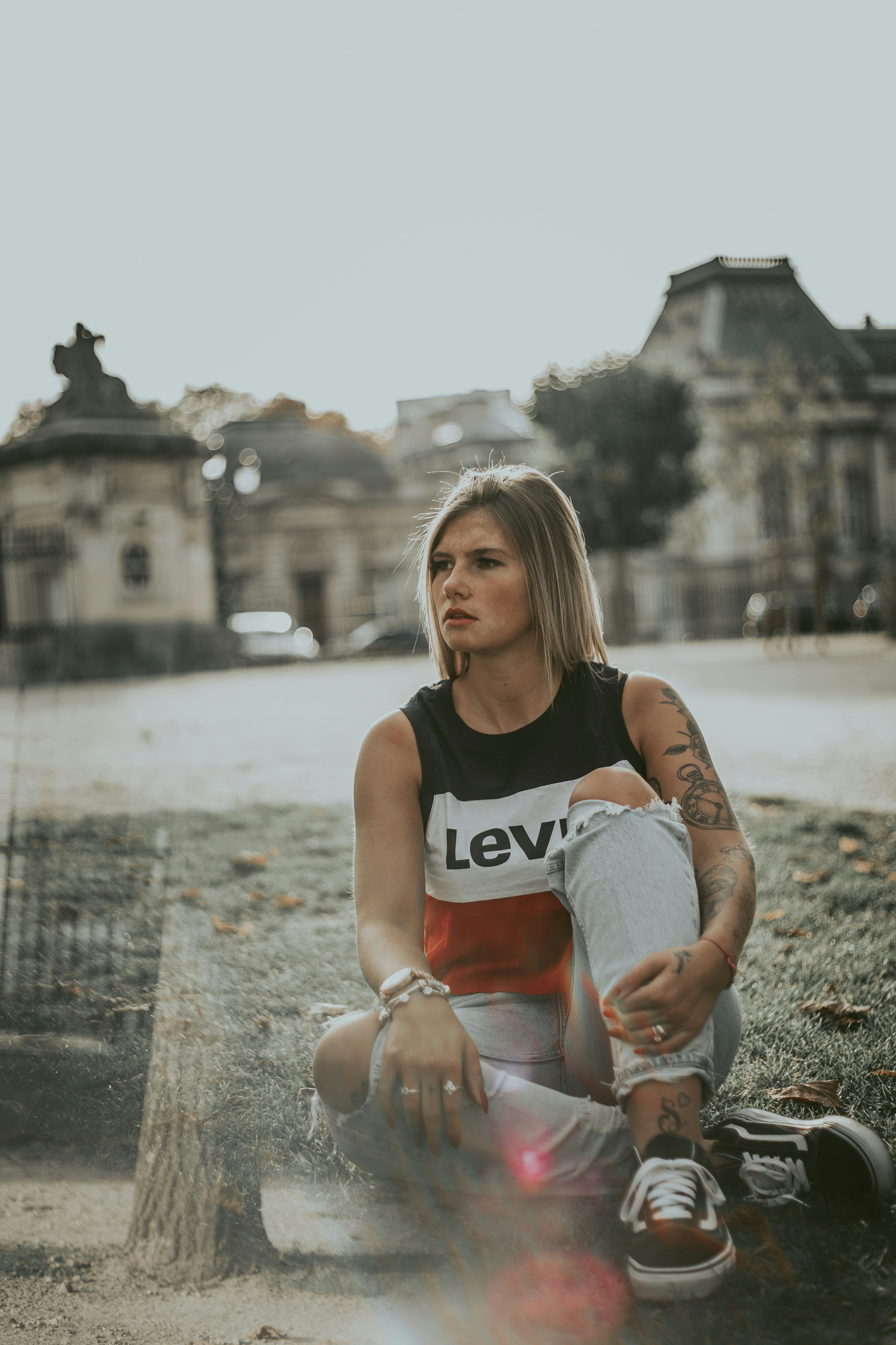 woman sitting near gray structure