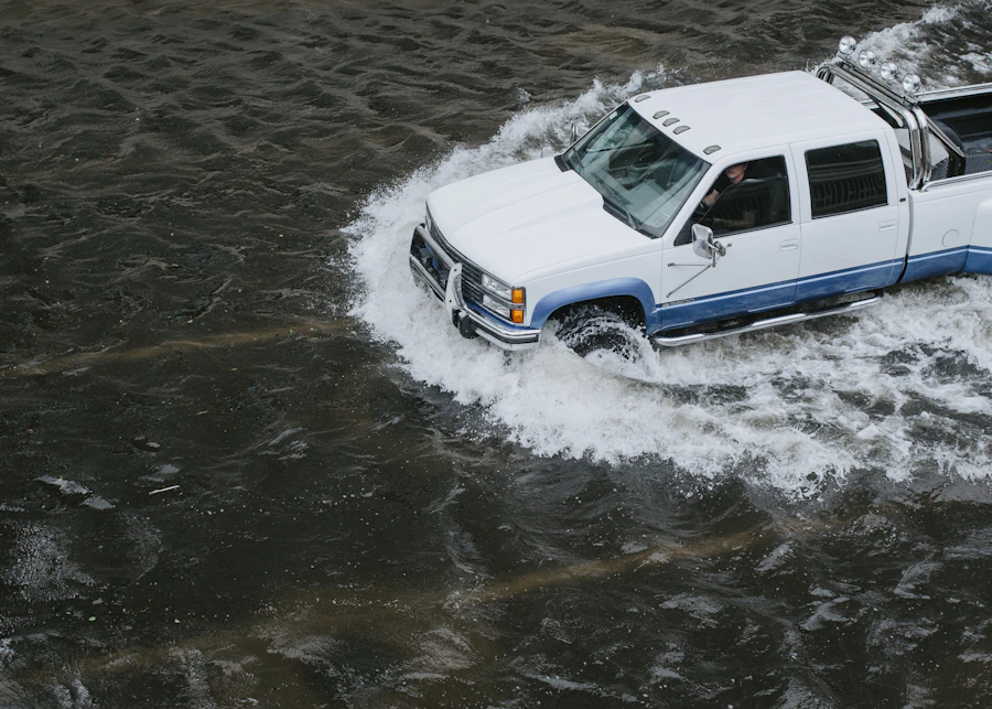 A pickup truck driving through floodwater