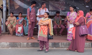 A group of happy passengers waiting at a bus stop served by Gustavo Silva Candizani