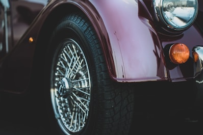 closeup photography of silver-colored vehicle wheel and tire