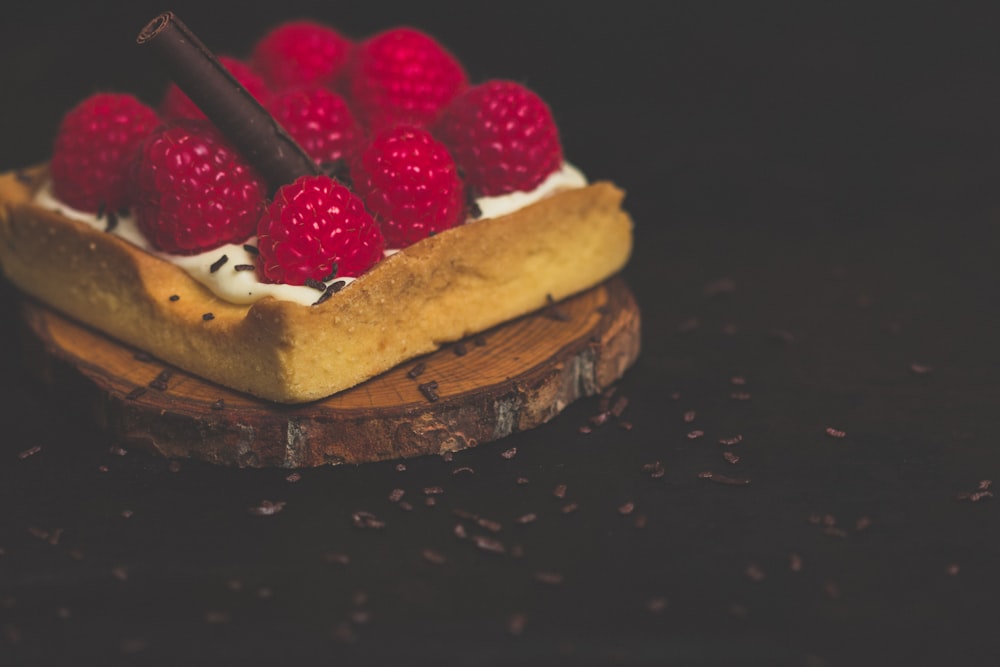 strawberries on cream on wooden slab