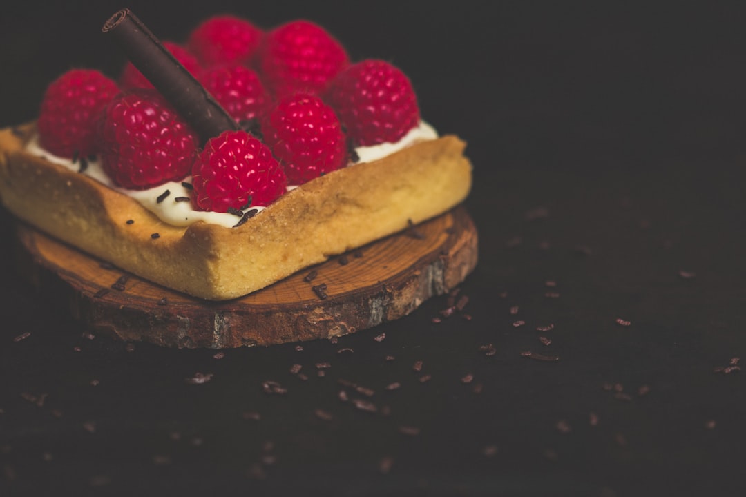 strawberries on cream on wooden slab,