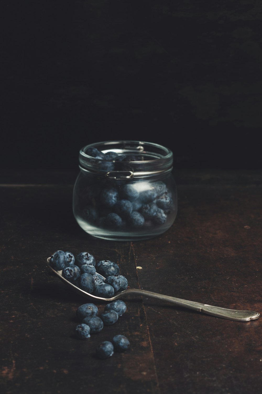 spoonful of blueberries from glass jar