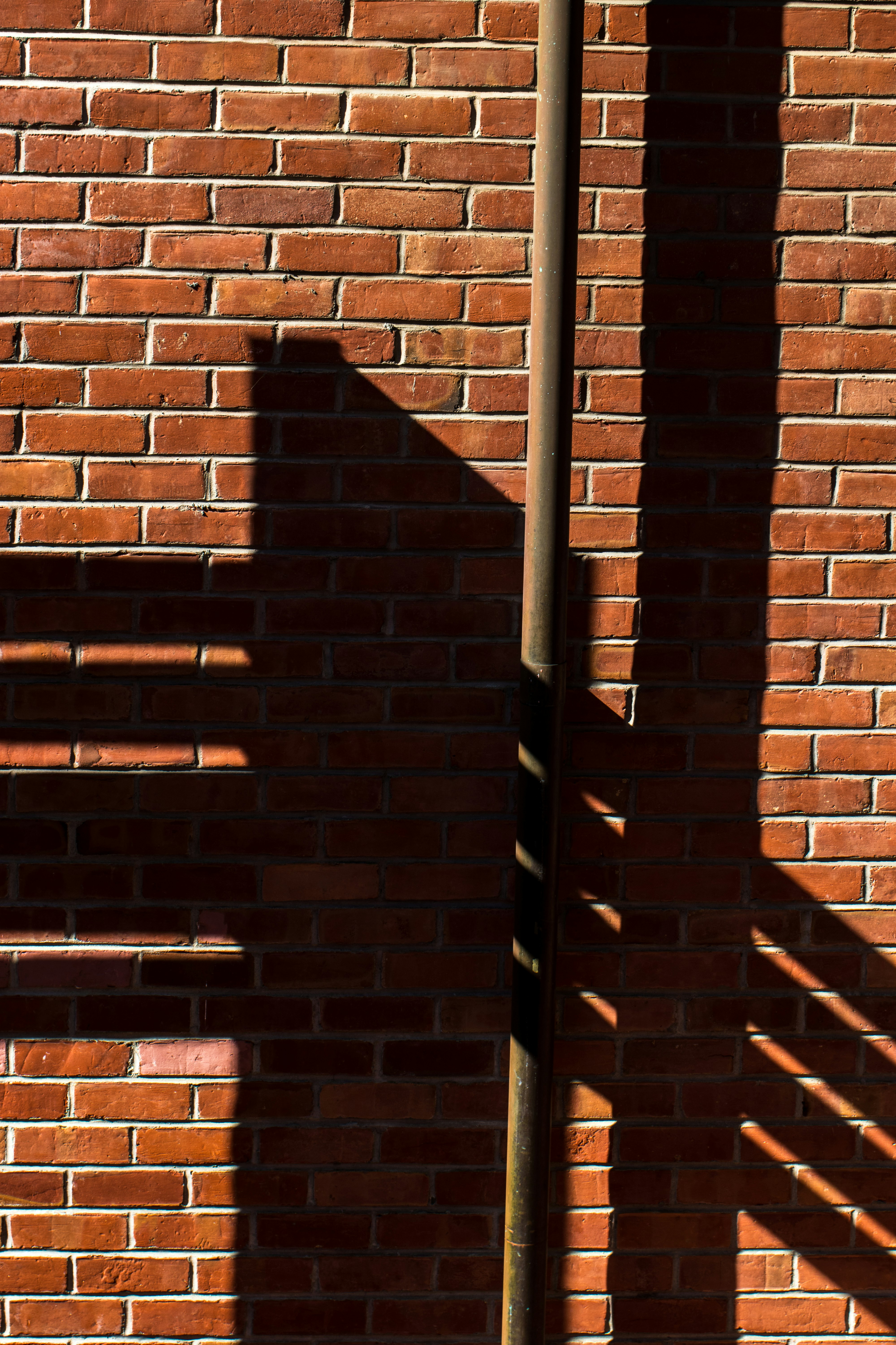 shadow on red brick wall