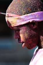 man with pink paint splattered hair and face