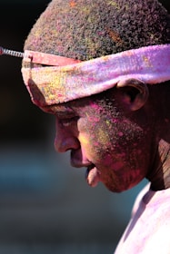 man with pink paint splattered hair and face