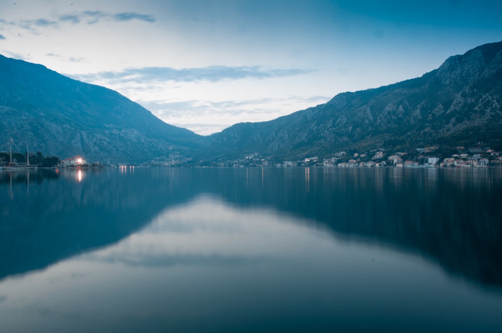 landscape photography of body of water surrounded by hills