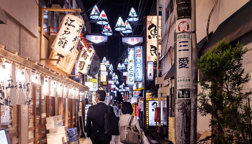 man and woman walking on alley