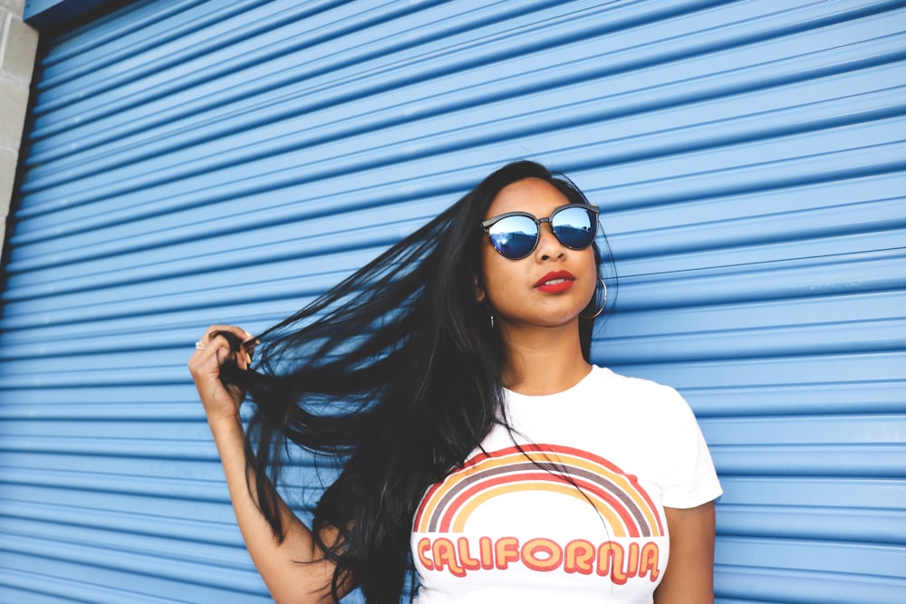 woman standing beside blue roller shutter