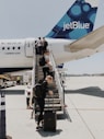 people walking on plane stair during daytime