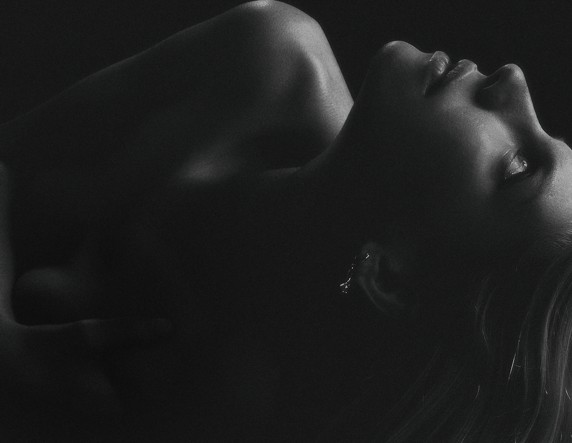 topless woman with black background