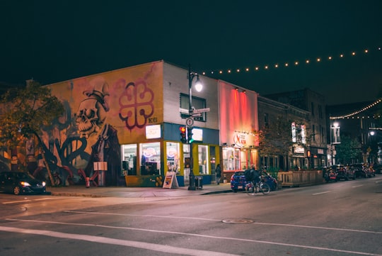 blue vehicle parked beside road during nighttime in Le Plateau-Mont-Royal Canada