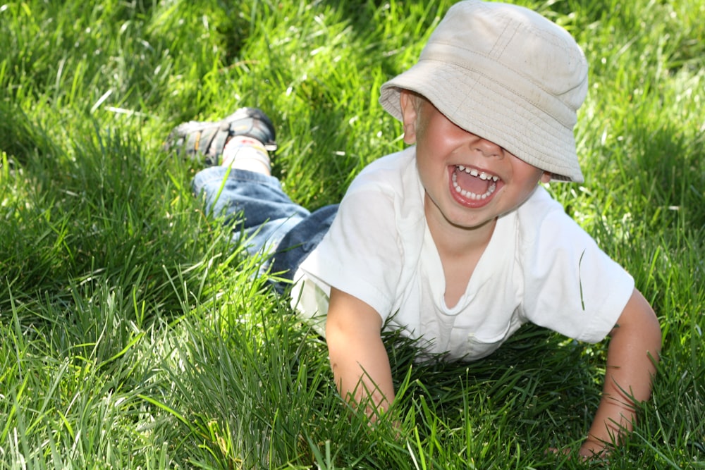 child lying on grass