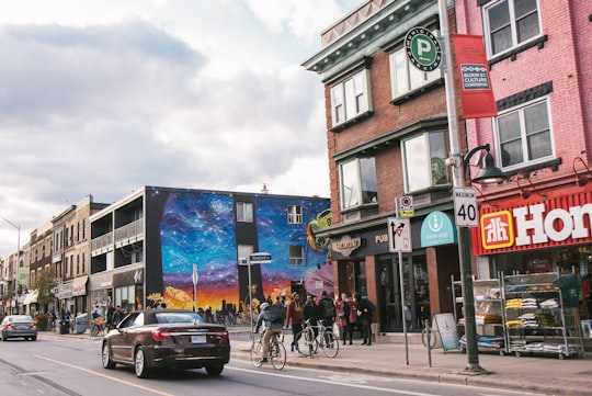 black vehicle traveling on road during daytime in The Annex Canada