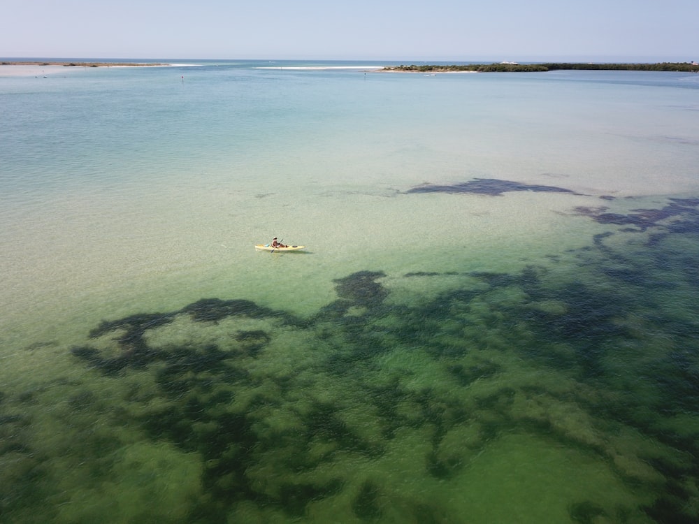 aerial photography of person sailing boat