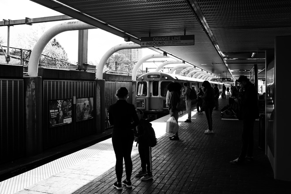 people waiting for the train to stop at the station