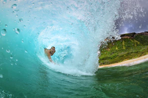 A surfer catching a wave near Jesolo Resort’s beachfront in Arugambay.