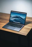 open macbook air on wooden desk