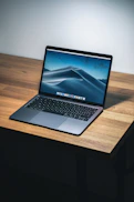 open macbook air on wooden desk
