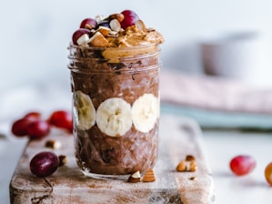fruits and cream in clear glass cup