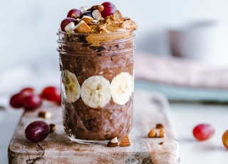 fruits and cream in clear glass cup