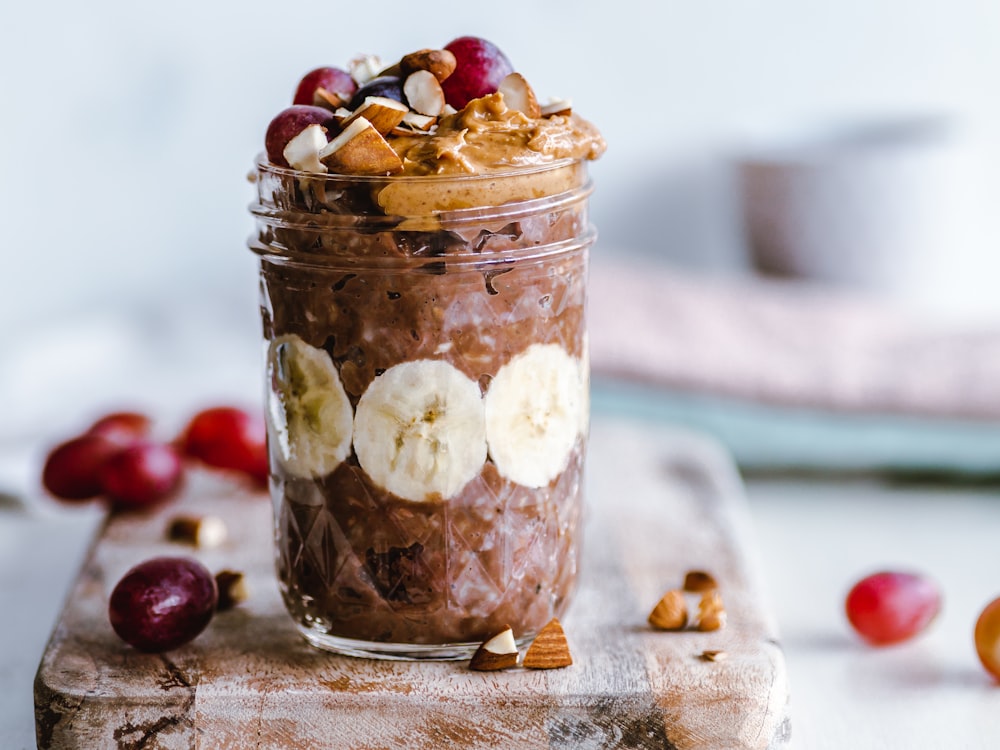 fruits and cream in clear glass cup