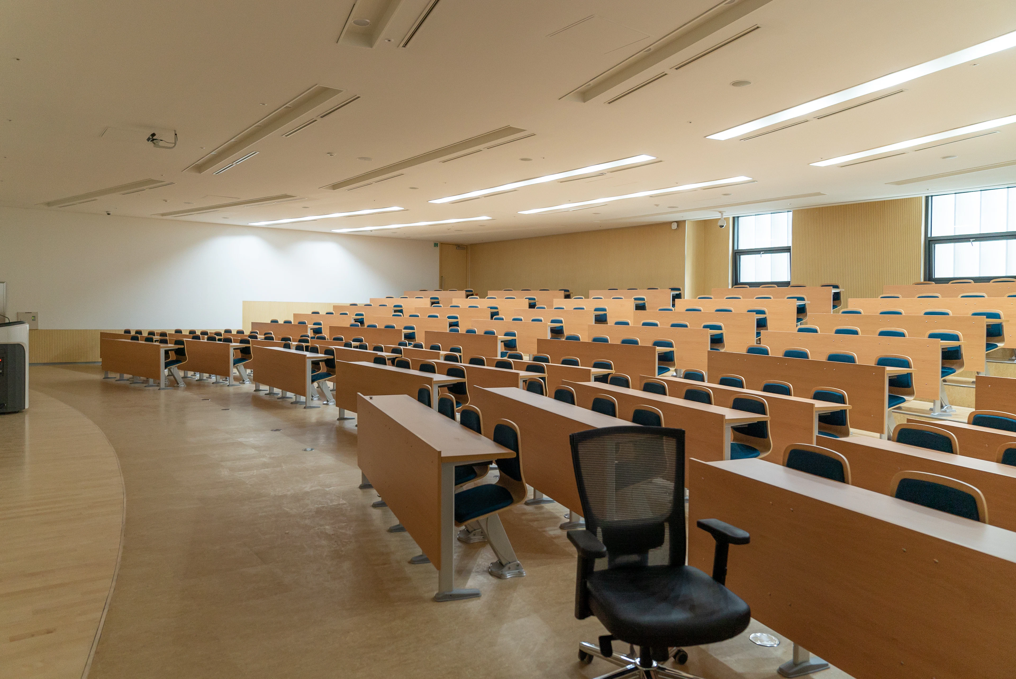 A modern, naturally lit classroom with rows of desks