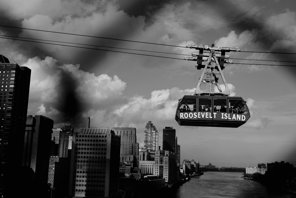 Roosevelt Island cable car on cable greyscale photography during daytime