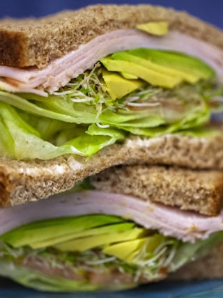 sandwich with ham and green vegetables